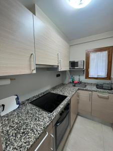 a kitchen with a sink and a counter top at Casa Isabel, wifi y relax - Arafita Apartamentos in Sallent de Gállego