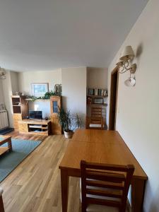 a living room with a wooden table and a dining room at Casa Isabel, wifi y relax - Arafita Apartamentos in Sallent de Gállego