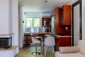 a kitchen with a table and chairs in a room at Corfu Glyfada Beach Apartment 13 in Glyfada