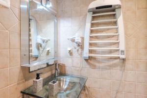 a bathroom with a sink and a mirror at Corfu Glyfada Beach Apartment 13 in Glyfada +63 photos