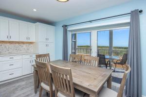 a kitchen and dining room with a wooden table and chairs at Unit D2 in Sanibel