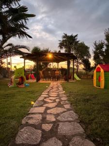 a stone path leading to a backyard with a gazebo at Villa Emara Mangana in Mángana