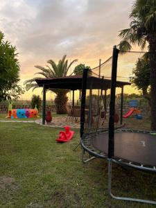 a playground with a swing set in a park at Villa Emara Mangana in Mángana