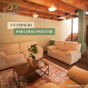 a living room with two couches and a table at El Zapote Casa de Descanso in Malinalco