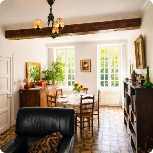a living room with a table and a couch at Le Jeu de Paume - Bail Partner in Mailly-le-Château