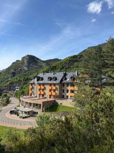 an aerial view of a building with a mountain in the background at Cozy apartment with mountain views in Panticosa