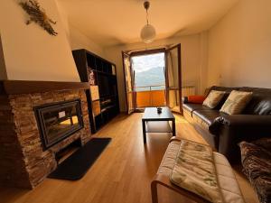 a living room with a couch and a fireplace at Cozy apartment with mountain views in Panticosa