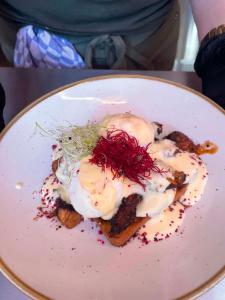 a plate of food with a poached egg on toast at Zaza Suites in Middelkerke