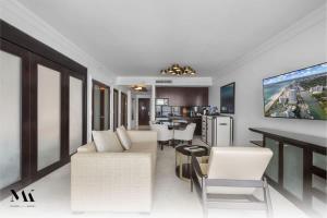 a living room with a white couch and a kitchen at Fontainebleau 2Dbl Queen Bed City plus Ocean View in Miami Beach