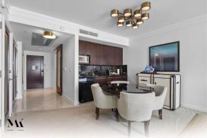 a kitchen and dining room with a table and chairs at Fontainebleau 2Dbl Queen Bed City plus Ocean View in Miami Beach
