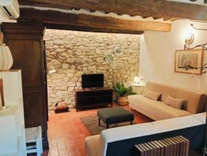 a living room with a couch and a tv at Tudesia Charming house in Todi