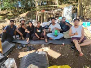 a group of people sitting on the ground at Camp Wildnest Adventures Ziro in Ziro