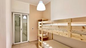 a room with two bunk beds and a lamp at Cilento HOME in Ogliastro Cilento