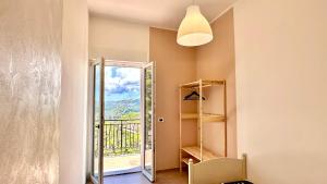 a room with a door leading to a balcony at Cilento HOME in Ogliastro Cilento