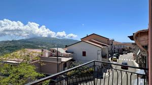 a view from a balcony of a town with a mountain at Cilento HOME in Ogliastro Cilento