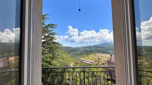 a window with a view of the mountains at Cilento HOME in Ogliastro Cilento +7 photos