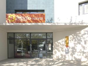 a building with anadobe access sign in front of a door at Aparthotel Adagio Access Avignon in Avignon
