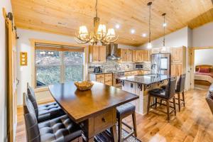a kitchen with a large wooden table and chairs at Little Bear in Maggie Valley