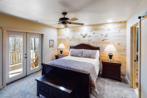 a bedroom with a bed and two lamps and a ceiling fan at Little Bear in Maggie Valley