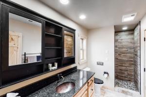 a bathroom with a sink and a large mirror at Little Bear in Maggie Valley +15 photos