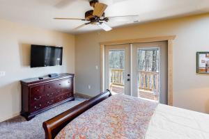 a bedroom with a bed and a flat screen tv at Little Bear in Maggie Valley