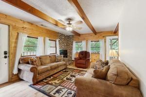 a living room with couches and a ceiling fan at Hollow's End in Whittier