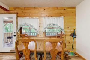 a dining room with a table and two chairs at Hollow's End in Whittier