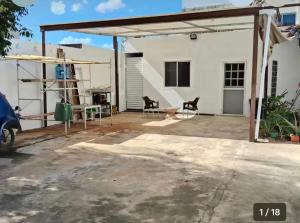 a house under construction with a garage at Casa Ross in Mérida