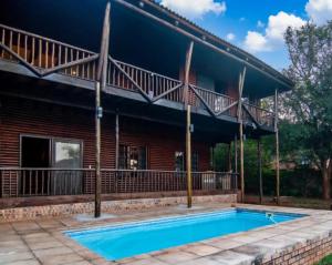 a house with a swimming pool in front of it at 56 Crocodile in Komatipoort