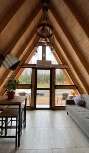 a living room with a large window and a chandelier at Refugio Alpino in Nacimiento
