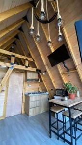 a kitchen with a table and chairs in a attic at Refugio Alpino in Nacimiento