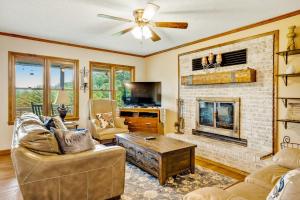 a living room with a couch and a fireplace at Angel View in Cullowhee
