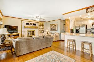a living room with a couch and a kitchen at Angel View in Cullowhee