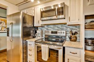 a kitchen with a stove and a refrigerator at Angel View in Cullowhee +30 photos