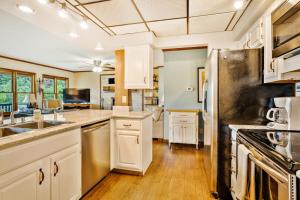 a kitchen with white cabinets and a stainless steel refrigerator at Angel View in Cullowhee