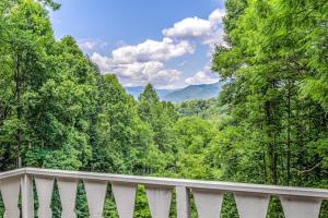 a white balcony with a view of the mountains at Grin and Bear It in Whittier