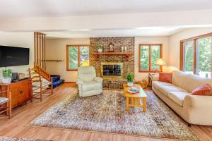 a living room with a couch and a fireplace at Grin and Bear It in Whittier