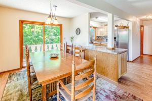 a dining room and kitchen with a wooden table and chairs at Grin and Bear It in Whittier