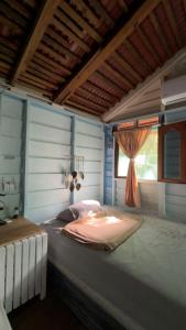 a large bed in a room with a window at Cabañas El paso Tulum in Chemuyil