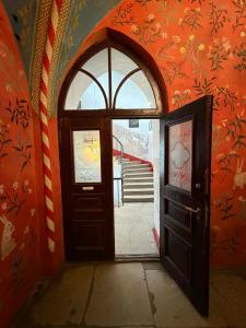 an open door in a room with an orange wall at Laitse Castle B&B in Laitse
