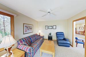 a living room with a couch and a chair at Narnia on Earth in Lake Lure