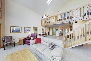 a living room with a couch and a staircase at Narnia on Earth in Lake Lure