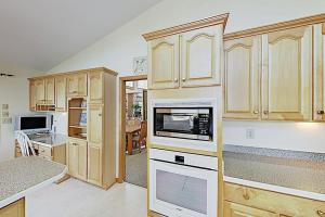 a kitchen with wooden cabinets and a microwave at Narnia on Earth in Lake Lure +28 photos