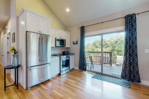 a kitchen with a stainless steel refrigerator and a balcony at Noble Sun in Fairview +17 photos