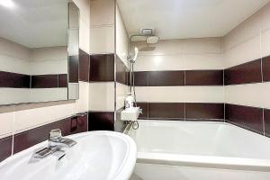a bathroom with a sink and a bath tub at Ramon Hotel in Seoul