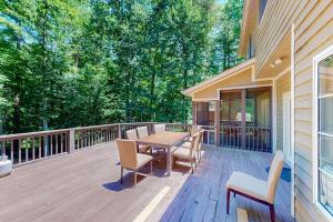 a wooden deck with a table and chairs on it at The Marlin in Arden