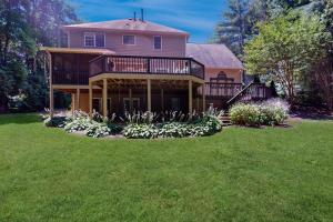 a large house with a large yard with flowers at The Marlin in Arden