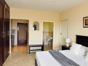 a bedroom with a bed and a bathroom at Ocean View Villas F05 in Port Edward +18 photos