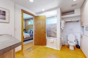 a bathroom with a toilet and a bedroom with a bed at The Lime House in Brevard +21 photos