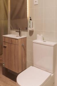 a bathroom with a white toilet and a sink at Manteiros Glamping in Canas de Senhorim +15 photos